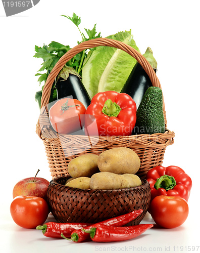 Image of Composition with raw vegetables and wicker basket