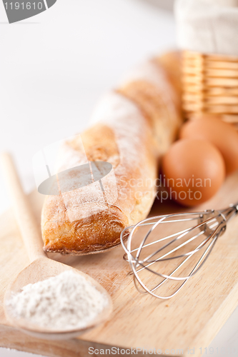 Image of bread, flour, eggs and kitchen utensil