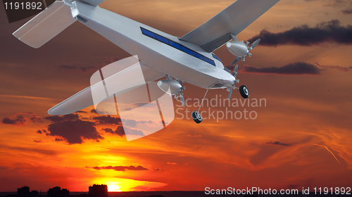 Image of Airplane in the sky at sunset