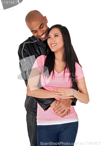 Image of Young couple embracing and smiling