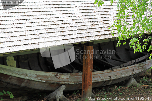 Image of Old boat house and a boat