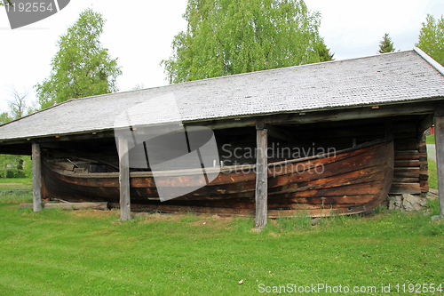 Image of Old boat house and a boat