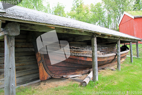 Image of Old boat house and a boat