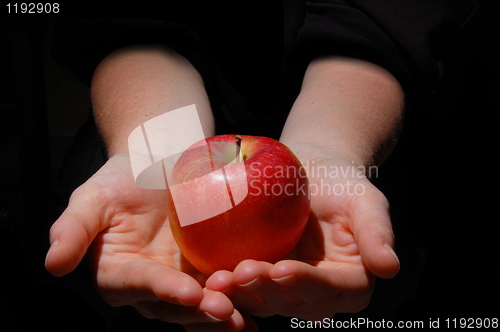 Image of hand with apple