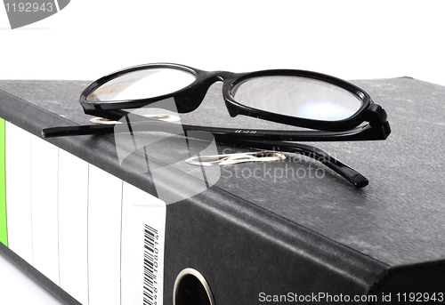 Image of eye glasses and folder