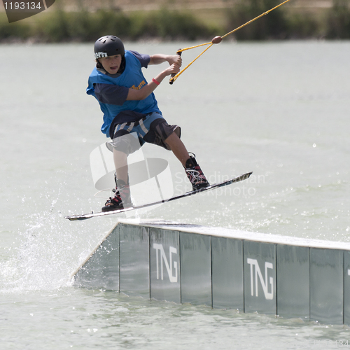 Image of Young boy rides his wakeboard