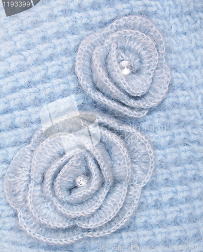 Image of Blue wool flowers on a blue wool background 