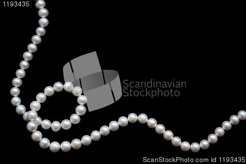 Image of White pearls on the black velvet 