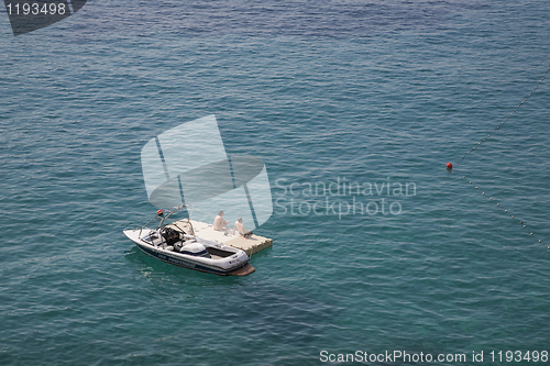 Image of Couple sunbathing on raft