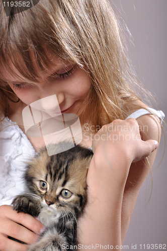 Image of chilld with a Persian kitten