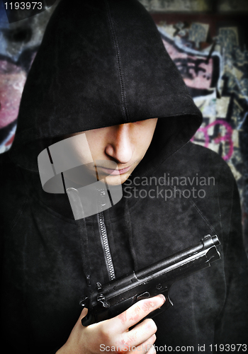 Image of One young man with hand gun