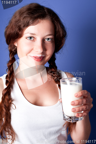 Image of young woman enjoying a glass milk 