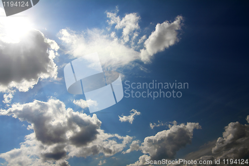 Image of clouds and sun on blue sky