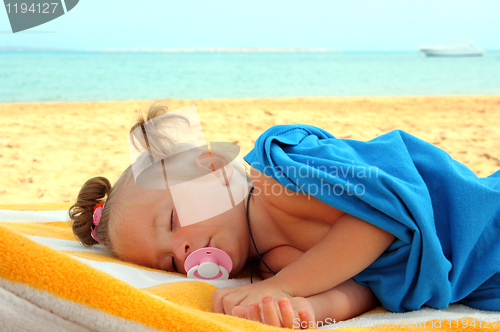 Image of little girl sleeping on beach