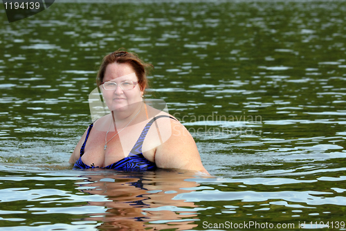 Image of plump woman bath in river