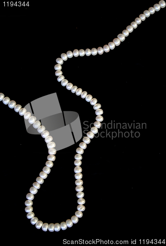 Image of White pearls on the black silk