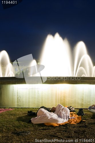 Image of editorial couple sleeping by fountain at The Assembly protest Ca