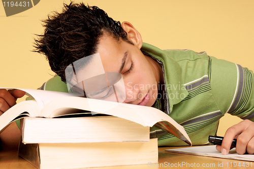 Image of Student sleeping on books