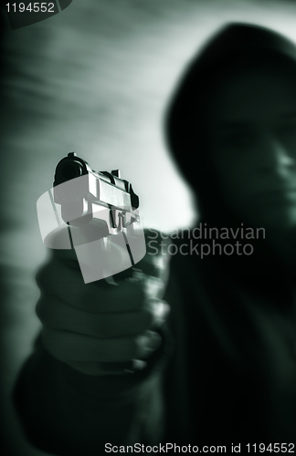 Image of One young man with hand gun