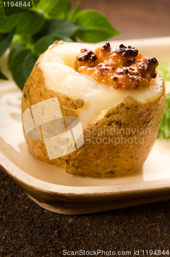 Image of Baked potato with sour cream, grain Dijon mustard and herbs