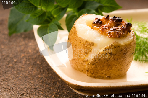 Image of Baked potato with sour cream, grain Dijon mustard and herbs