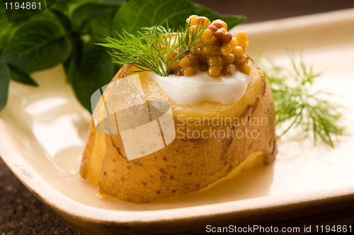 Image of Baked potato with sour cream, grain Dijon mustard and herbs