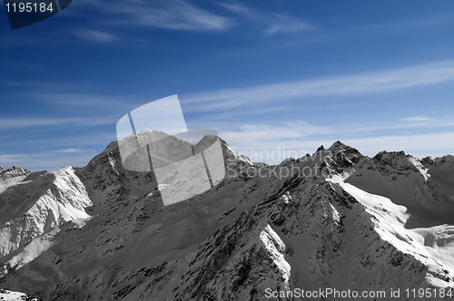 Image of Black and white mountains against blue sky