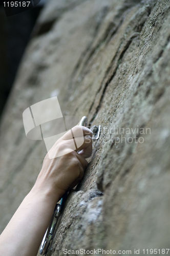 Image of Climbers hand and quick-draws 