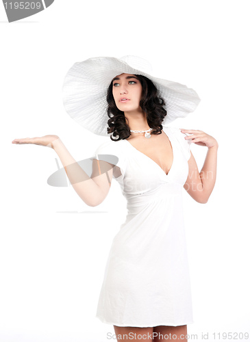 Image of young woman in white dress and hat