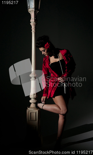 Image of young woman and lightpole