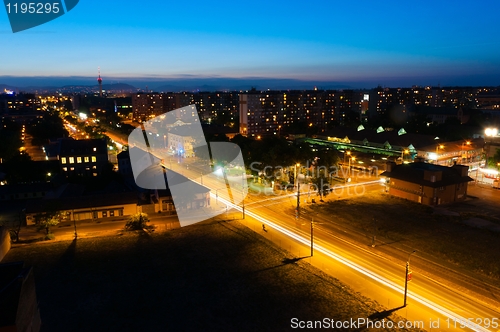 Image of Night shot of a busy city with apartments and lights