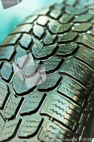 Image of Wet car tire texture in green and blue colors