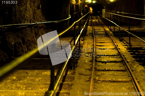 Image of Railway in abandoned mine with yellow lights