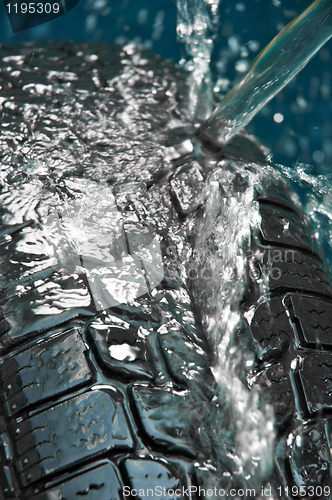 Image of Washing tire on blue blurry background