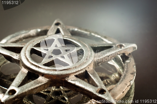 Image of pentagram with reflection in the mirror an light 