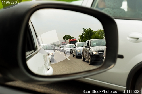 Image of Traffic jam trough car mirror