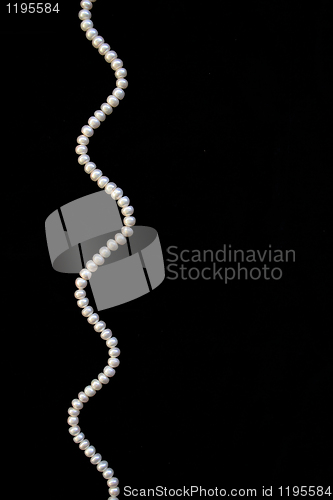 Image of White pearls on the black silk 