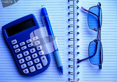 Image of calculator, pencil and glasses