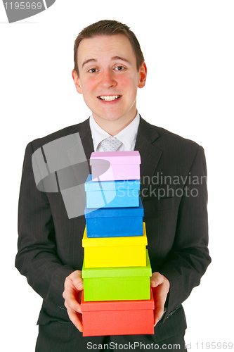 Image of Young businessman with gift boxes