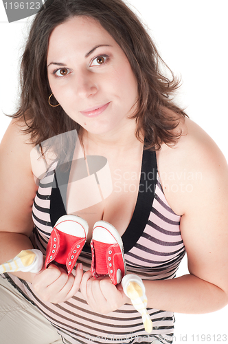 Image of Portrait of pretty pregnant woman baby shoes