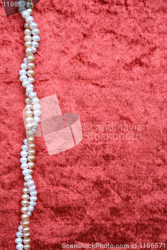Image of White and pink pearls on the terracotta velvet 