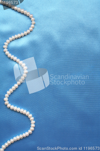 Image of Pearls on the smooth elegant blue silk as background