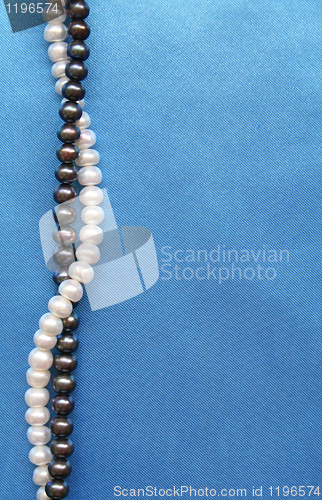 Image of Pearls on the smooth elegant blue silk as background