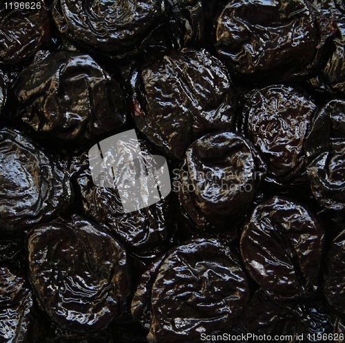 Image of Dry plums or prunes fruit as background 