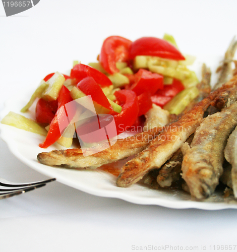 Image of Fish -smelt in flour crust appetizer with salad on the plate