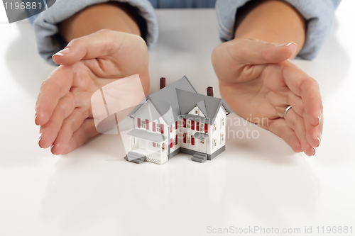 Image of Womans Hands Around Model House