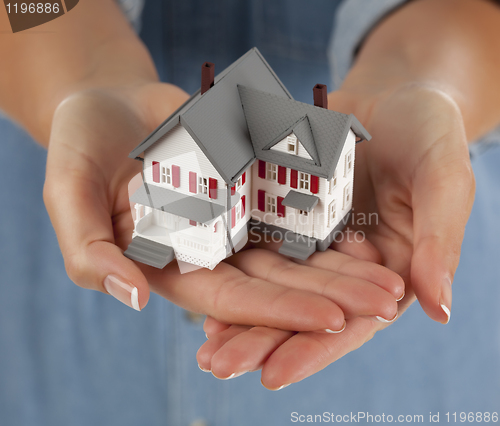 Image of Woman Holding Model Home in Hands