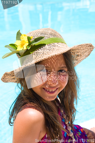 Image of Little girl wearing a hat near pool