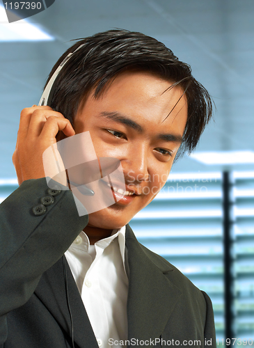 Image of Male Sales Representative In His Office Talking On A Headset