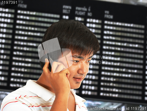 Image of Man Talking On His Mobile Phone In An Airport